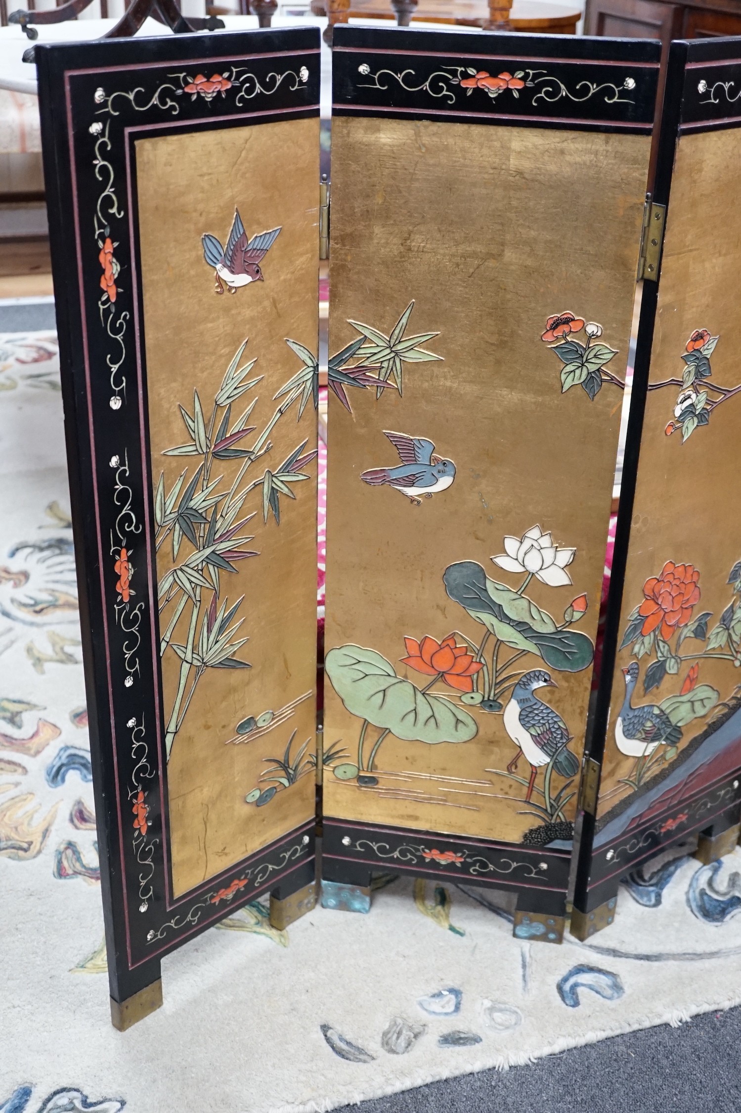 A Chinese ‘coromandel’ lacquer low four fold screen, height 92cm *Please note the sale commences at 9am.